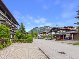 a cobblestone street in a village with a mountain at Alpenblick 5 - Chiemgau Karte in Inzell