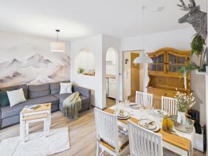 a living room with a couch and a table at Alpenblick 5 - Chiemgau Karte in Inzell