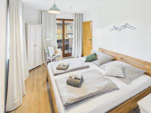a large white bed with two pillows on it at Alpenblick 5 - Chiemgau Karte in Inzell