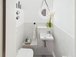 a white bathroom with a toilet and a sink at Alpenblick 5 - Chiemgau Karte in Inzell