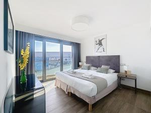 a bedroom with a bed and a large window at 7 Croisette in Cannes