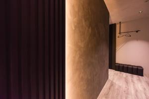 a room with a stone wall and a mirror at 貳宿文旅 in Tainan