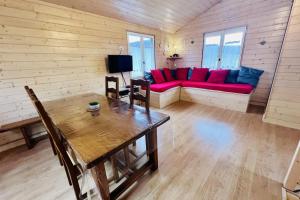 a living room with a couch and a table at Chalet le Petit Coeur in Xonrupt-Longemer +25 photos