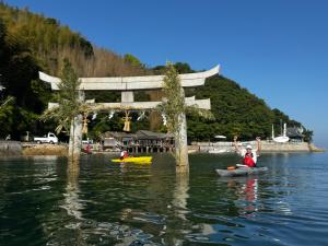 a group of people in kayaks on the water with at The Nine Kings in Imabari