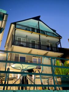 a building with a balcony with a table in front of it at Casa Corina Dubova in Dubova