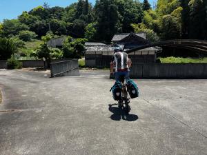 a man riding a bike in a parking lot at The Nine Kings in Imabari