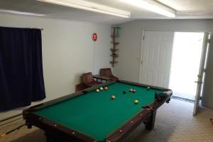 a room with a pool table with balls on it at The Shack in Oak Hill