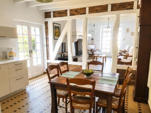 a kitchen and dining room with a table and chairs at Champan in Toulouzette