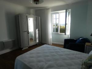 a bedroom with a bed and a dresser and a window at Champan in Toulouzette