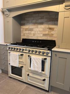 a kitchen with a stove with two towels on it at Harehills House in Killingbeck