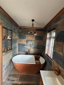 a bathroom with a large tub and a sink at Harehills House in Killingbeck +27 photos
