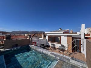 a swimming pool on the roof of a building at Amaranta Hotel Boutique in Ronda