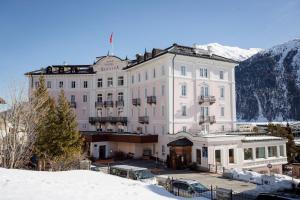 a large white building with snow on the ground at TH Samedan - Hotel Bernina 1865 in Samedan