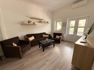 a living room with a couch and a table at Balaton Bloom Vendégház in Siófok