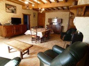 a living room with a table and a couch at Maison lacabane in Saint-Sever
