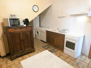 a small kitchen with a sink and a microwave at Maison lacabane in Saint-Sever