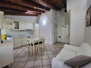 a kitchen and a living room with a table and chairs at Residence Villa Stufler in Modena +20 photos