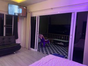 a room with a couch and a room with a balcony at Ocean View Tuggi Klong Prao in Klong Prao Beach