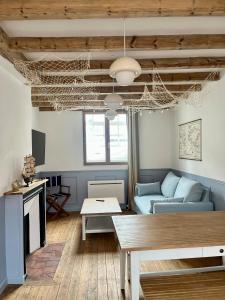 a living room with a blue couch and a table at l'Ocean in Dieppe