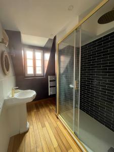 a bathroom with a shower and a sink at l'Ocean in Dieppe
