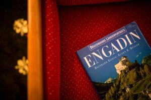 a book sitting on top of a red pillow at TH Samedan - Hotel Bernina 1865 in Samedan +105 photos