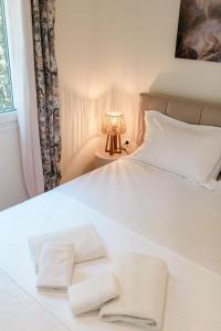 a white bed with two white towels on it at Corfu Dream Apartment Chrysion in Glyfada +44 photos