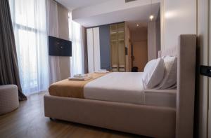 a bedroom with a large bed and a large window at Waves Hotel NEW IN 2026 in Sarajevo