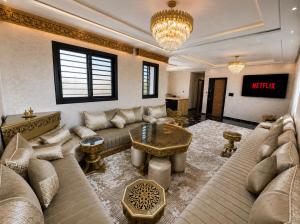 a living room with a couch and a table at Appart Hidaya in Fez