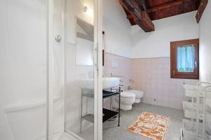 a bathroom with a sink and a toilet at Cozy Country Loft Oleandro in Chioggia +24 photos