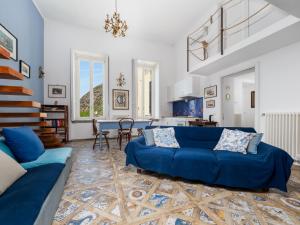 a living room with a blue couch and a table at De Vivo Realty - Coco's Apartments in Meta