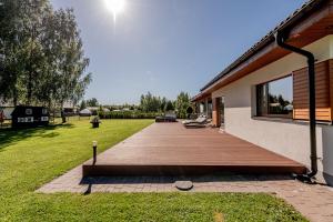 a wooden deck in front of a house at Valgekodu Pesa in Papsaare