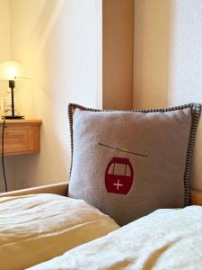 a pillow with a picture of a train on it at Panorama Apartment Gotschnablick 1-6 Pers in Klosters +21 photos