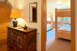 a room with a lamp on a dresser and a bedroom at Panorama Apartment Gotschnablick 1-6 Pers in Klosters