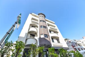 a white building with trees in front of it at 貳宿文旅 in Tainan