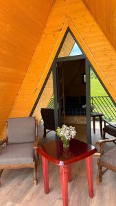 a room with a table and a chair and a glass door at Dsegh Eco Home in Dsegh