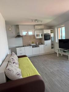 a living room with a couch and a kitchen at Lana&Ema in Kali