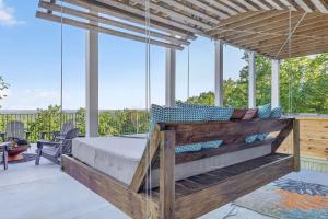 a porch with a bed on a patio at Mountain View Escape in Taylors
