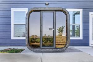 a large mirror in front of a blue house at Mountain View Escape in Taylors