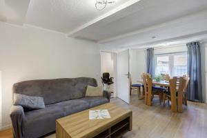 a living room with a couch and a table at Haus Schnettler mit Sauna in Bestwig