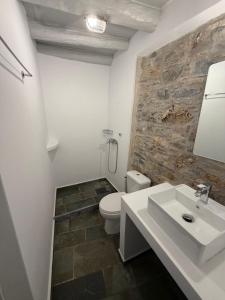 a bathroom with a white toilet and a sink at Samos Vista Azzurra 2 in Samos