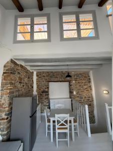 a kitchen and dining room with a table and chairs at Samos Vista Azzurra 2 in Samos