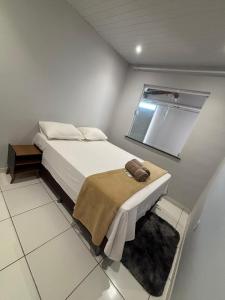 a bedroom with a large bed with a window at RODRIGUES CASA de TEMPORADA em Barreirinhas in Barreirinhas