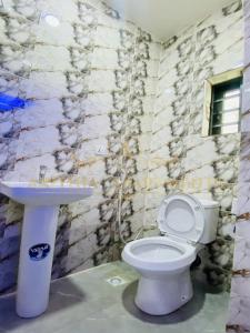 a bathroom with a toilet and a sink at Arithia Apartments in Mama