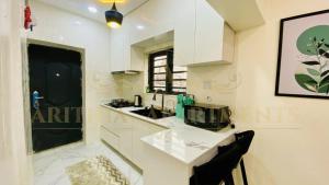 a white kitchen with a sink and a counter at Arithia Apartments in Mama +10 photos