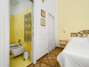 a bedroom with a bed and a sink and a tub at De Vivo Realty - Coco's Apartments in Meta +63 photos