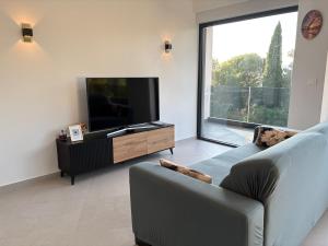 a living room with a couch and a flat screen tv at Luxury Apartment The Best in Cavtat