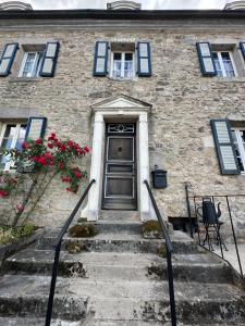 a brick building with stairs leading to a door at MAISON LA TRANQUILITÉ by Frans & Ricardo in Saint-Didier-sur-Arroux