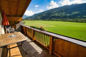 a balcony with a table and a view of a field at Appartement Sandra in Stumm