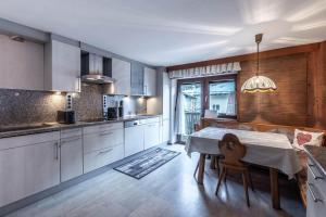 a kitchen with a table and a dining room at Appartement Tschol in Flirsch