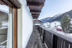 a balcony with a view of a snow covered mountain at Appartement Tschol in Flirsch